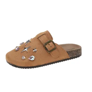 Stylish brown suede closed-toe slippers featuring silver star studs and colorful crystal gems