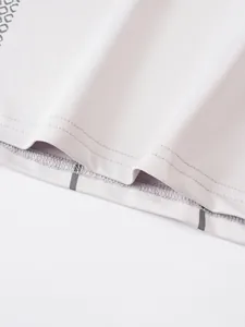 Close-up of the hem stitching and elastic fabric texture of a men's athletic compression shirt.