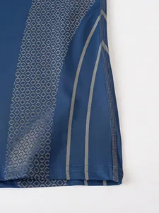 Close-up detail of a men's athletic compression shirt showing hexagonal print and side seam