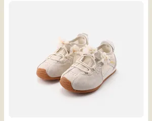 Detailed view of girls' sneakers featuring 3D floral accents and breathable mesh