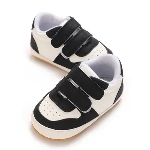 Close-up of black and white baby walking shoes with soft non-slip rubber soles