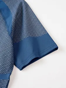 Detail of blue compression t-shirt sleeve featuring geometric pattern and stitching.