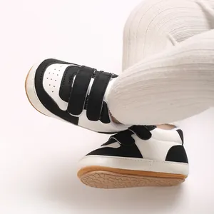 Close-up of black and white baby walking shoes with soft non-slip rubber soles