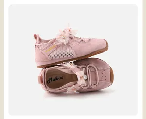 Detail of pink girls' sneakers featuring 3D floral ornaments and breathable mesh panels
