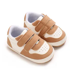 Detail view of brown and white baby walker shoes with soft non-slip rubber soles