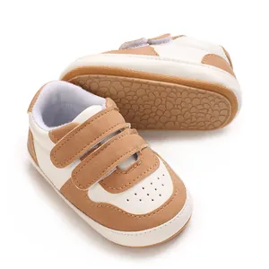 Detail view of brown and white baby walking shoes with soft non-slip soles and velcro
