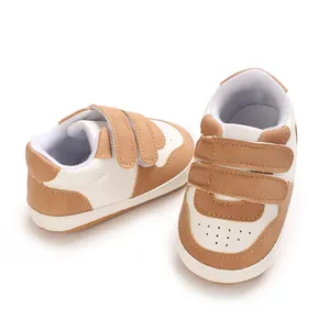 Detailed view of baby walking shoes featuring soft rubber soles and hook-and-loop straps.