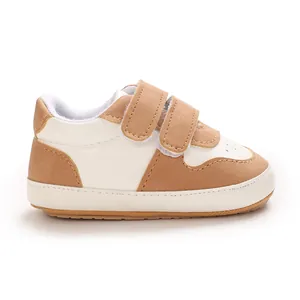 Macro view of cream and brown baby walking shoes featuring a soft non-slip rubber sole