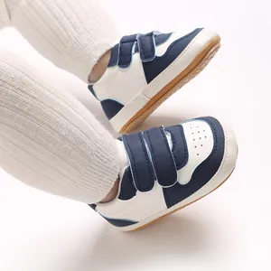 Close-up view of baby walker shoes featuring blue and white panels and soft rubber soles