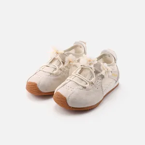Stylish beige girls' mesh sneakers featuring floral pearl accents and soft rubber soles
