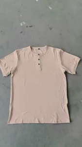 Detail of men's khaki ribbed Henley T-shirt featuring three buttons and a loose knit fit.