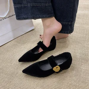 Detailaufnahme schwarzer spitzer Mary Jane Schuhe mit goldener Schnalle
