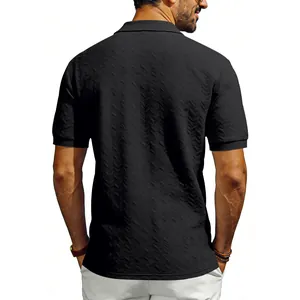 Detail view of the black men's polo shirt featuring a textured chevron pattern and slim fit.