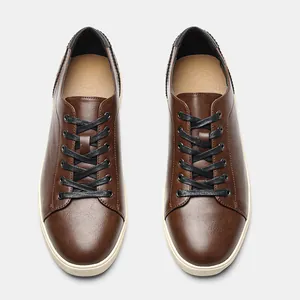 Detail showing top-down view of men's brown casual sneakers with black laces.
