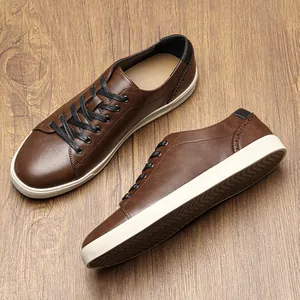 Close-up of brown men's casual leather sneakers featuring classic white rubber soles.