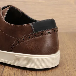 Close-up of brown casual shoe heel featuring brogue perforation details and white sole.