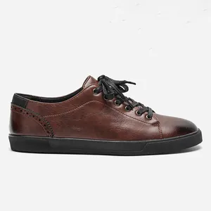 Side view of men's brown leather casual shoes with black laces and brogue detail