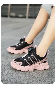 Detailed view of breathable mesh children's sneakers with rotary buckle closure.