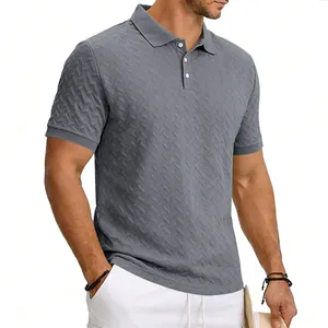 Detail view of men's grey polo shirt featuring an elegant textured chevron knit pattern.
