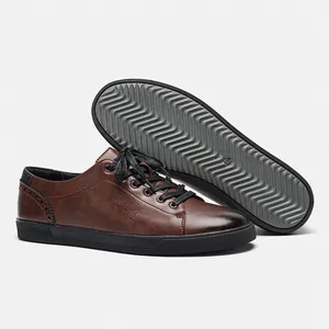 Detailed view of men's brown casual leather shoes showing the non-slip wavy sole pattern