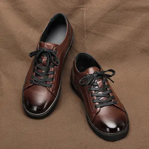 Detailed view of brown men's casual leather shoes with black laces on textured fabric