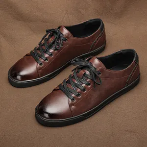 Macro view of men's brown casual leather shoes with black laces and rubber soles.