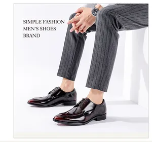 Professional close-up of glossy burgundy patent leather men's business dress shoes