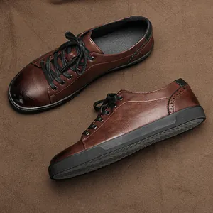 Detailed side and top view of men's brown leather casual board shoes with black rubber soles