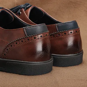 Detailed view of brown leather brogue sneakers showing heel and stitching quality