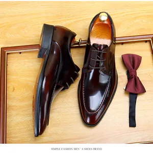 Detailed view of glossy burgundy men's dress shoes with matching bow tie