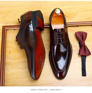 Detailed top view of premium shiny burgundy patent leather men's formal dress shoes