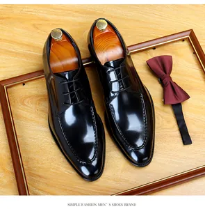 Detailed top view of black patent leather men's formal dress shoes in a classic style.