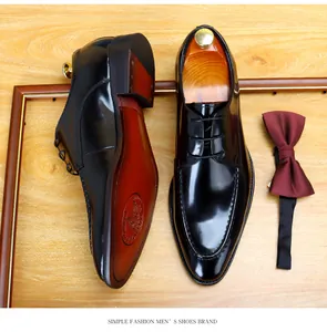 Macro view of glossy black patent leather men's dress shoes with wooden shoe tree