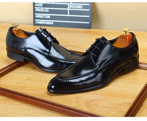 Detail view of premium black patent leather men's formal dress shoes with glossy finish.