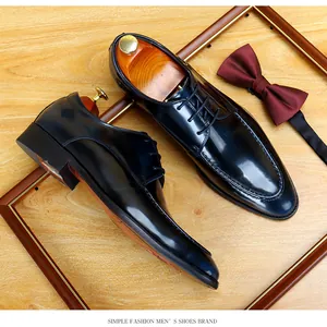 Detailed top view of high-quality shiny black patent leather men's formal business dress shoes