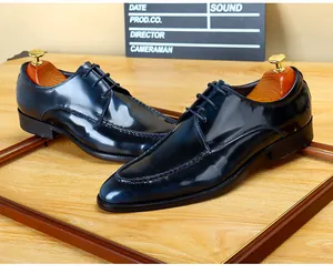 Elegant glossy dark blue patent leather dress shoes for men in classic British business style