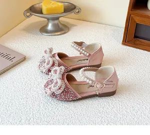 Detail of pink glitter princess shoes for girls with pearl bow and ankle strap