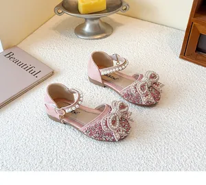 Detailed view of pink girls princess shoes with sparkling rhinestones and pearl bow