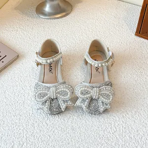 Silver sequined princess shoes for girls with pearl-encrusted bow and ankle strap