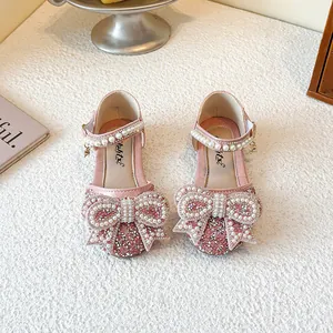 Sparkling pink princess shoes for girls with large rhinestone bow and elegant pearl strap