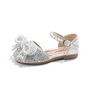 Elegant silver glitter girls princess sandals featuring a large pearl bow and strap