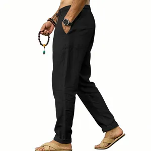 Side profile detail of men's loose black linen trousers for casual and vacation wear.