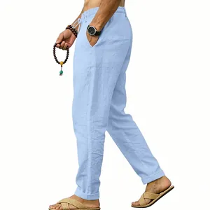 Close-up detail of men's light blue linen casual trousers with an elastic drawstring waist.