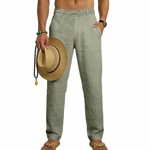 Detailed texture of sage green men's linen pants with drawstring waist and loose fit