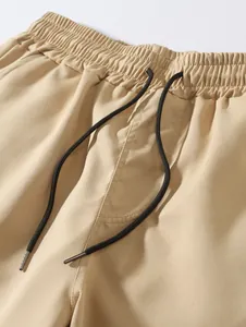 Gros plan sur la taille élastique et le cordon de serrage des shorts de plage kaki
