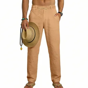 Detail showing the relaxed fit and drawstring waist of the khaki linen trousers on model