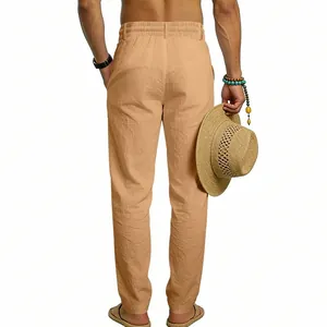 Back view of men's tan linen casual straight pants showing relaxed fit and texture