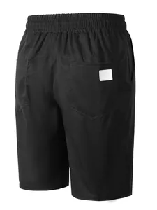 Vue arrière détaillée d'un short de plage noir pour homme en tissu tissé avec taille élastique.
