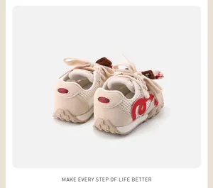 Detailed view of cream baby mesh sneakers with red bow accents and COTD logo on heel.