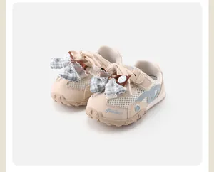Detailed macro view of toddler girl breathable mesh sneakers with lace bow accents